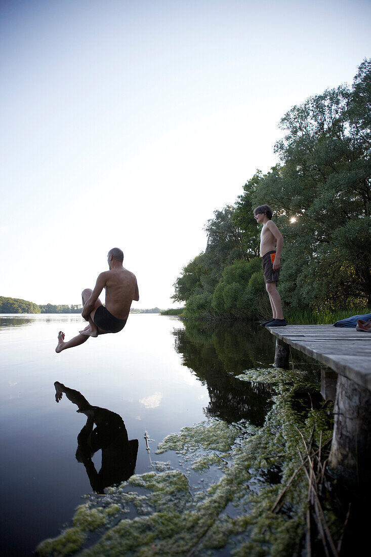 Man jumping into lake Goldensee, Klein Thurow, Roggendorf, Mecklenburg-Western Pomerania, Germany