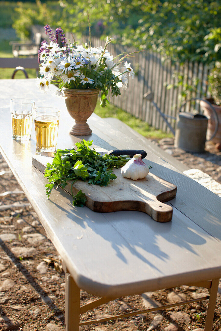 Table with a bunch of flowers an fresh herbs in a garden, Klein Thurow, Roggendorf, Mecklenburg-Western Pomerania, Germany