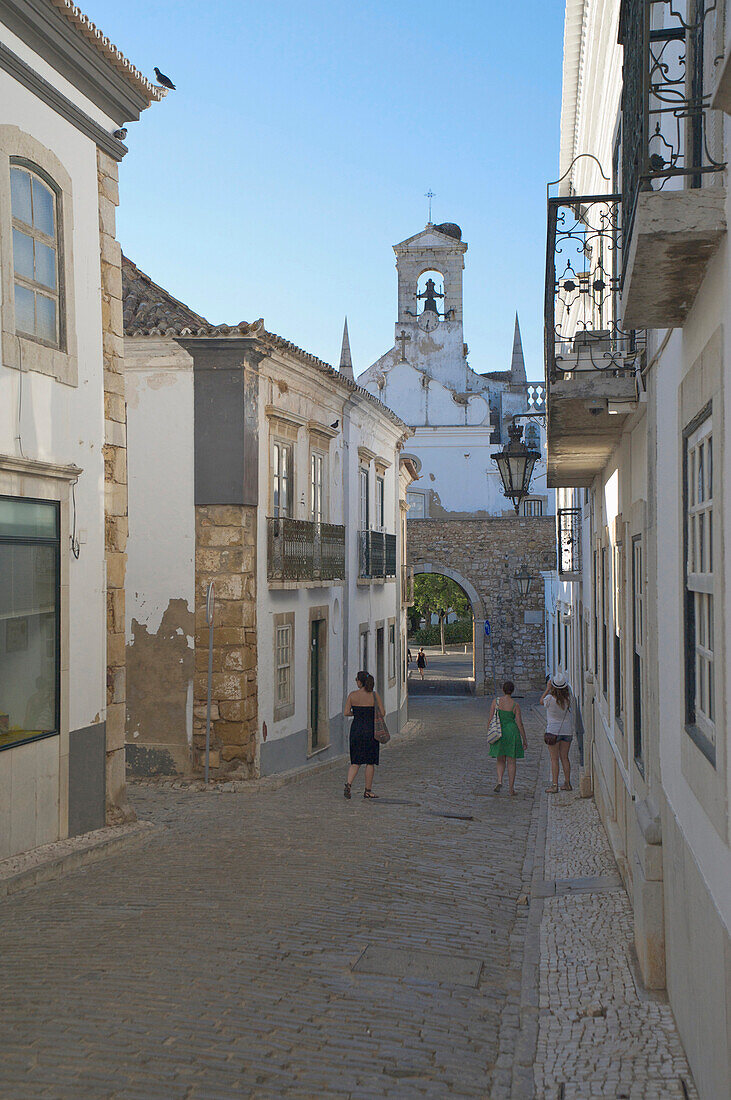 Cobbled street with city gate, Old town, Cidade Velha, Faro, Algarve, Portugal, Europe