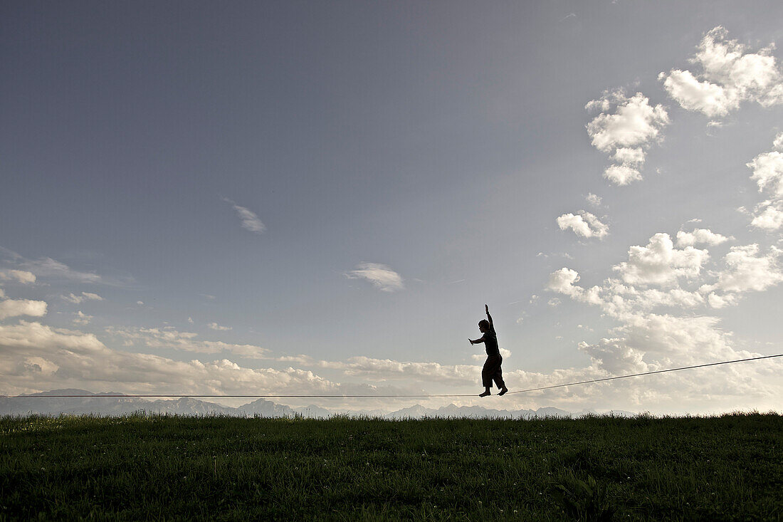 Young man balancing on a longline, Auerberg, Bavaria, Germany, Europe