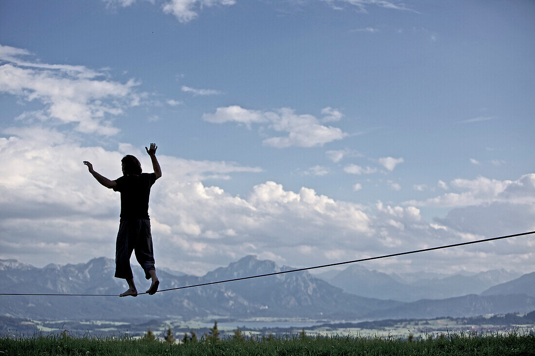 Young man balancing on a longline, Auerberg, Bavaria, Germany, Europe
