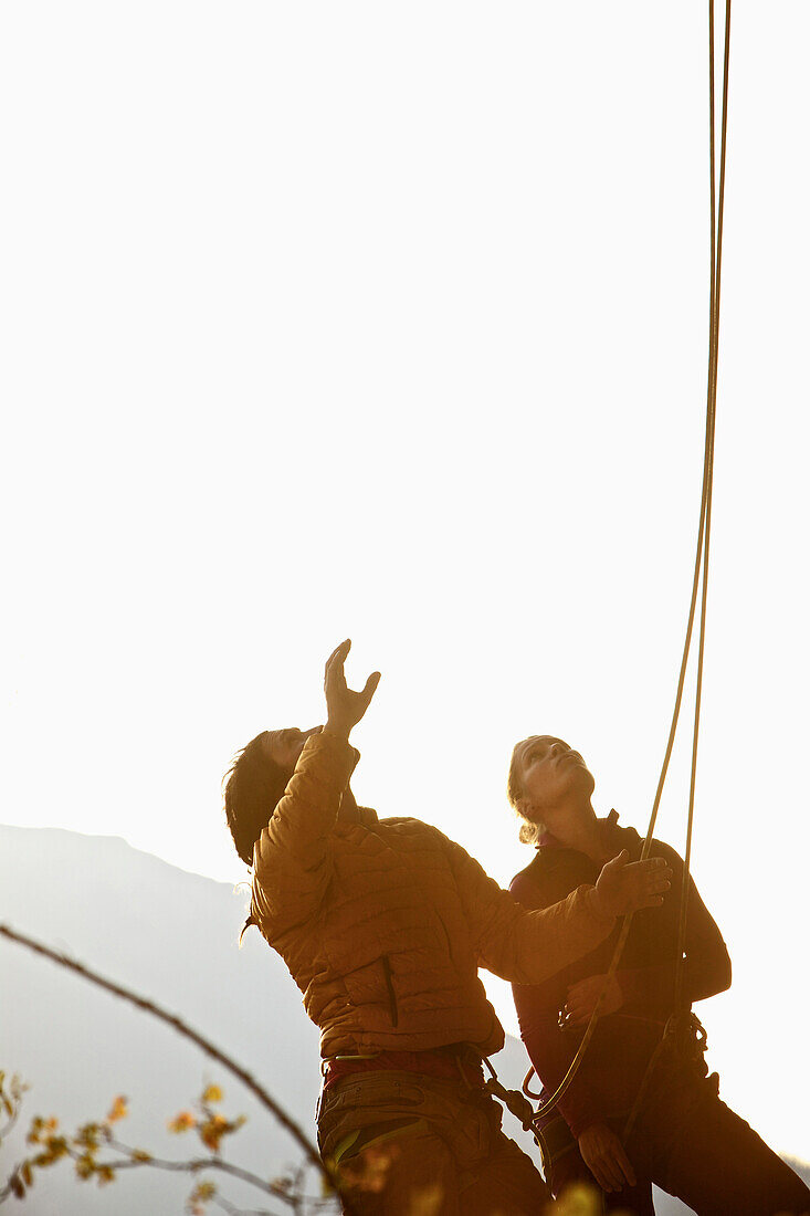 Two climbers at a rock face on a sunny day, Pinswang, Tyrol, Austria, Europe