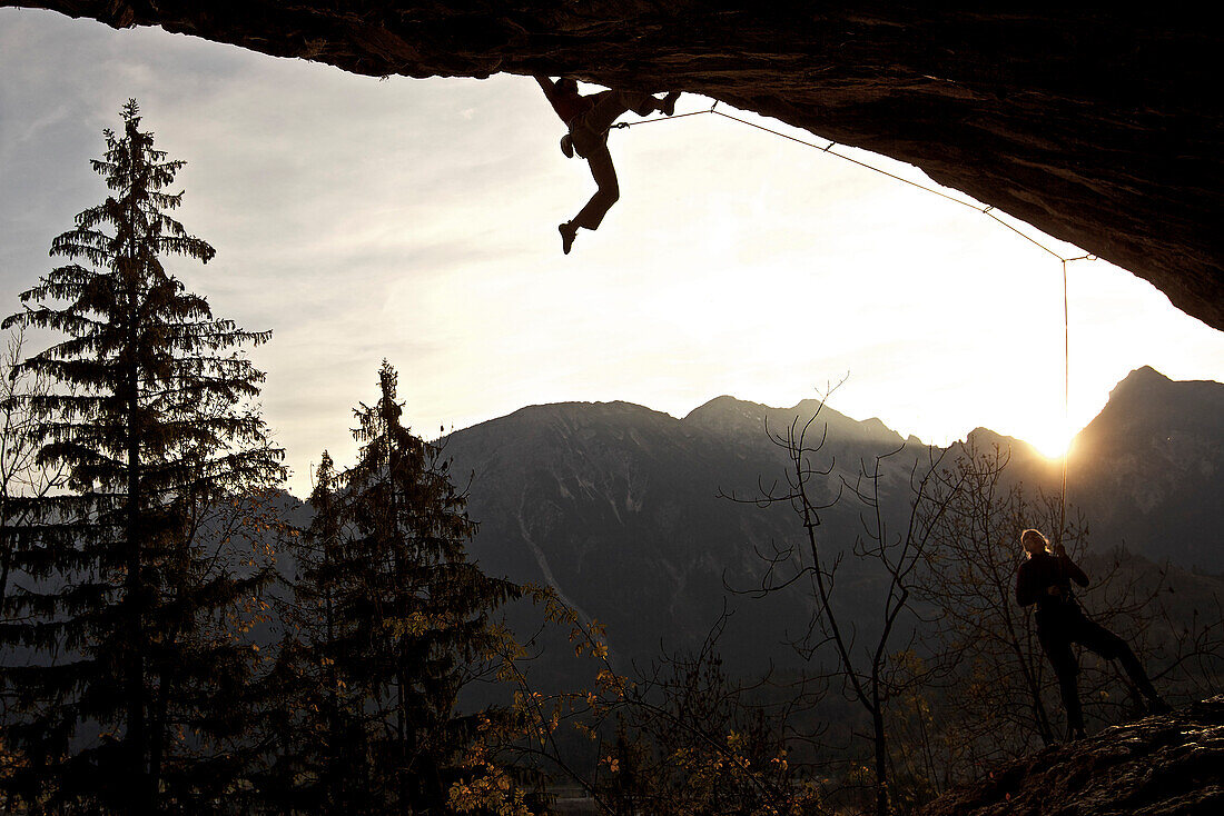 Two climbers at a rock face on a sunny day, Pinswang, Tyrol, Austria, Europe