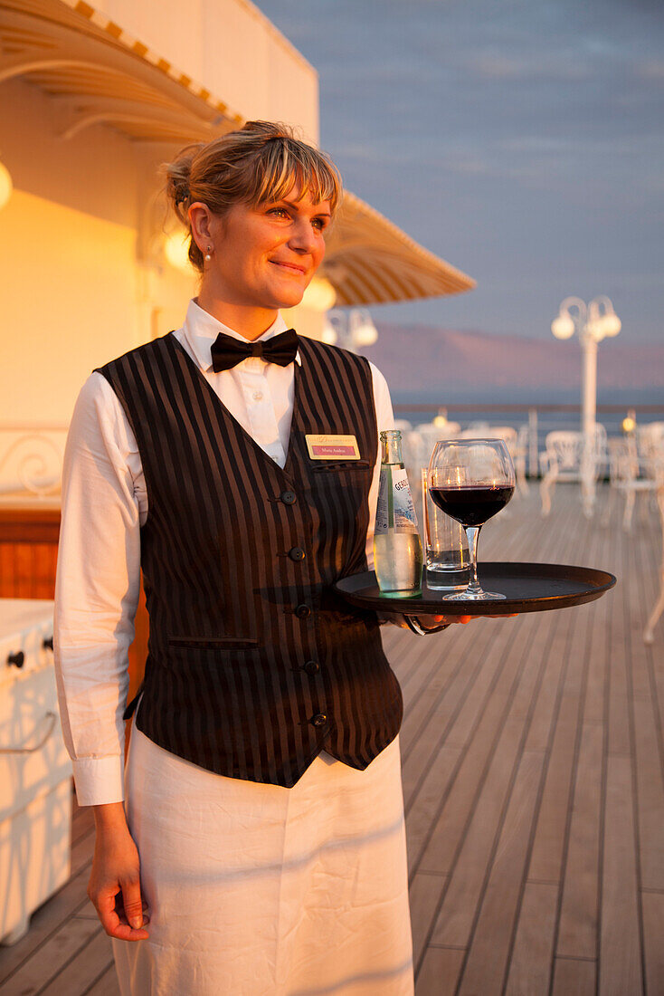 Golden waitress Maria aboard cruise ship MS Deutschland, Reederei Peter Deilmann, South Pacific Ocean, near Chile, South America