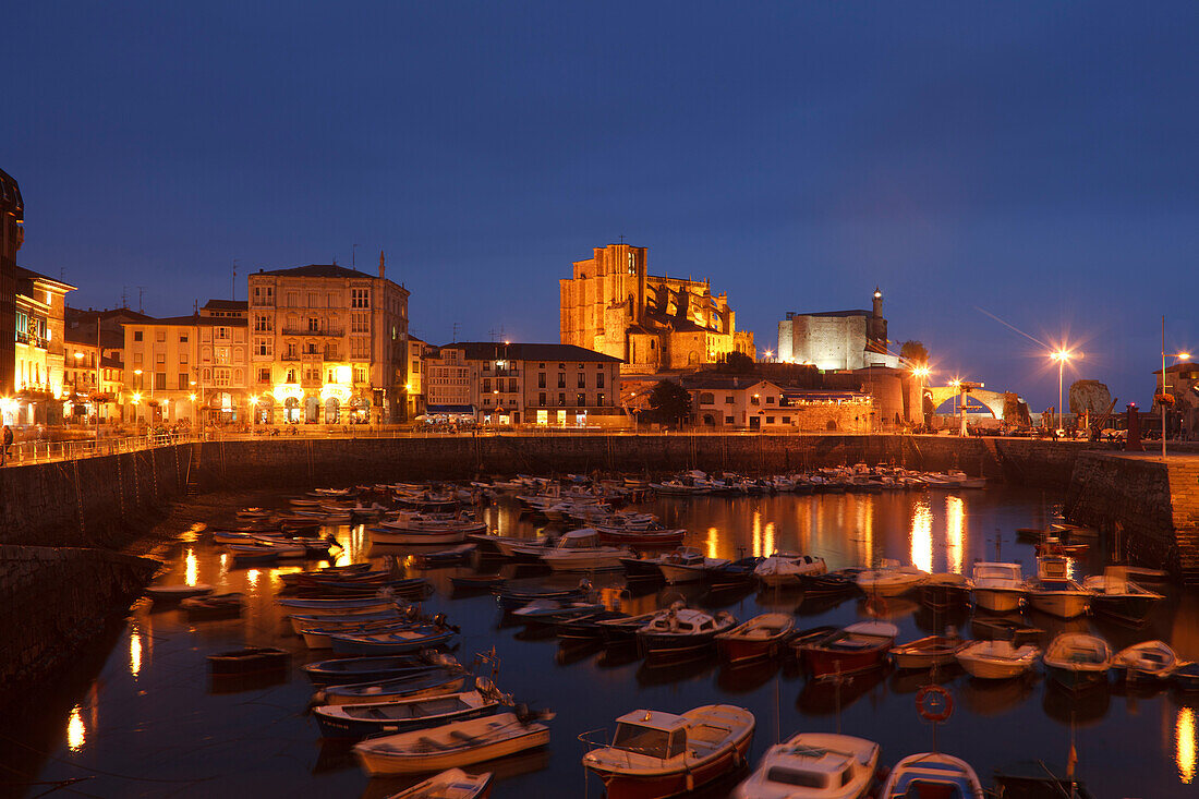 Boats at fishing port and the church Iglesia de Santa Maria de Asuncion in the evening, Castro Urdiales, Camino de la Costa, Camino del Norte, coastal route, Way of St. James, Camino de Santiago, pilgrims way, province of Cantabria, Cantabria, Northern Sp