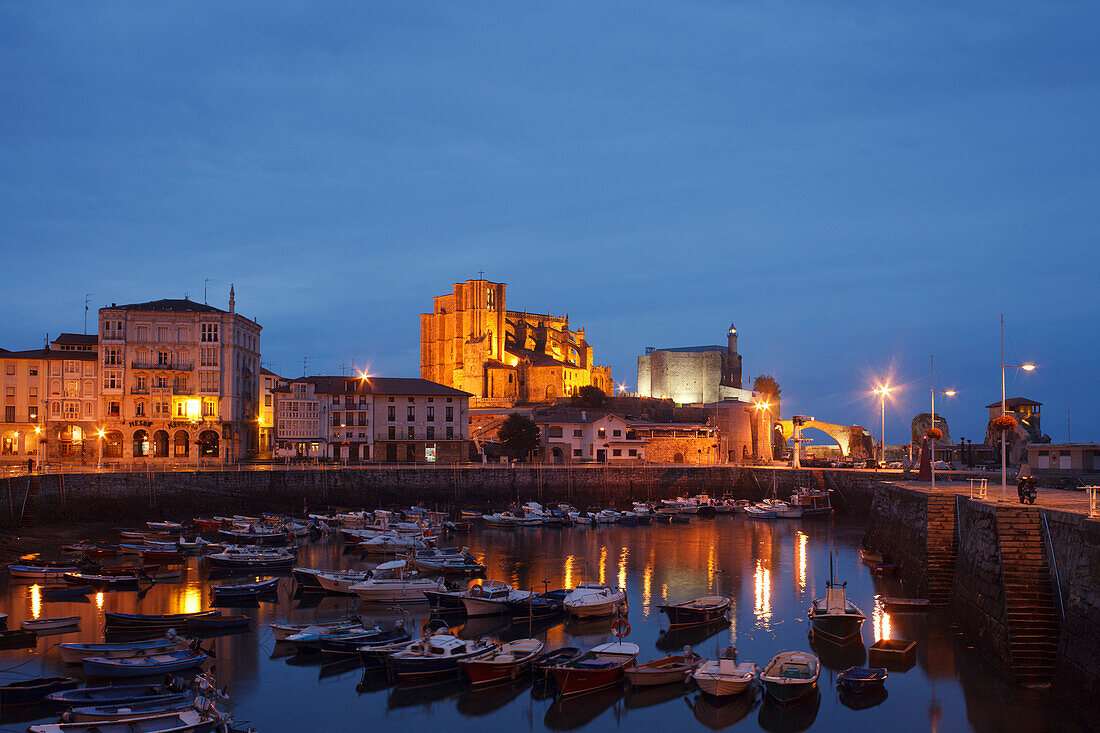 Boats at fishing port and the church Iglesia de Santa Maria de Asuncion in the evening, Castro Urdiales, Camino de la Costa, Camino del Norte, coastal route, Way of St. James, Camino de Santiago, pilgrims way, province of Cantabria, Cantabria, Northern Sp