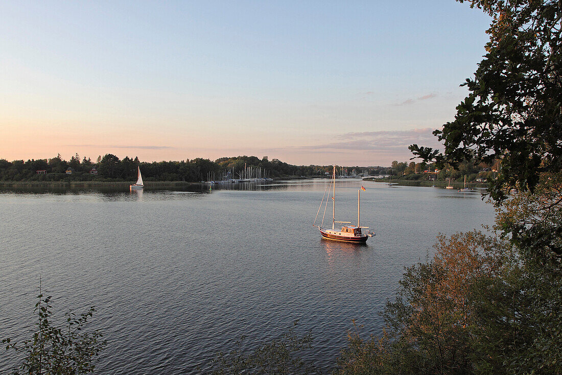 View from the southbank of the Schlei onto the village of Missunde at dusk, Schlei, Schleswig-Holstein, Germany, Europe