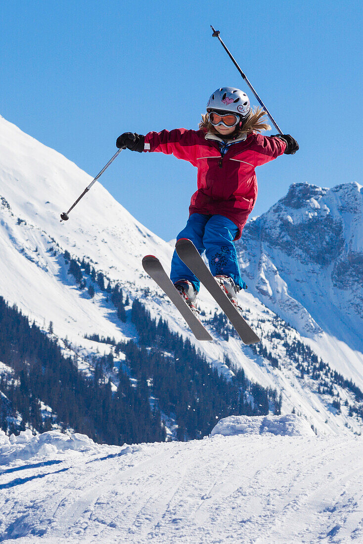 A girl on skis jumping, Skiresort Wiriehorn, Diemtigtal valley, Bernese Oberland, Switzerland, Europe
