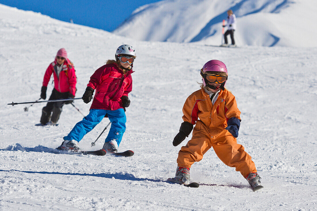 A woman and two children, girls skiing, Skiresort Wiriehorn, Diemtigtal valley, Bernese Oberland, Switzerland, Europe