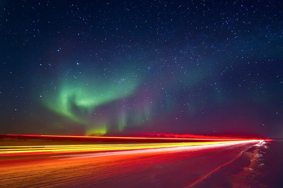 Aurora Borealis Northern Polar Lights with truckers lights on the ice road outside Yellowknife, Northwest Territories, Canada, MORE INFO The term aurora borealis was coined by Pierre Gassendi in 1621 from the Roman goddess of dawn, Aurora, and the Greek n