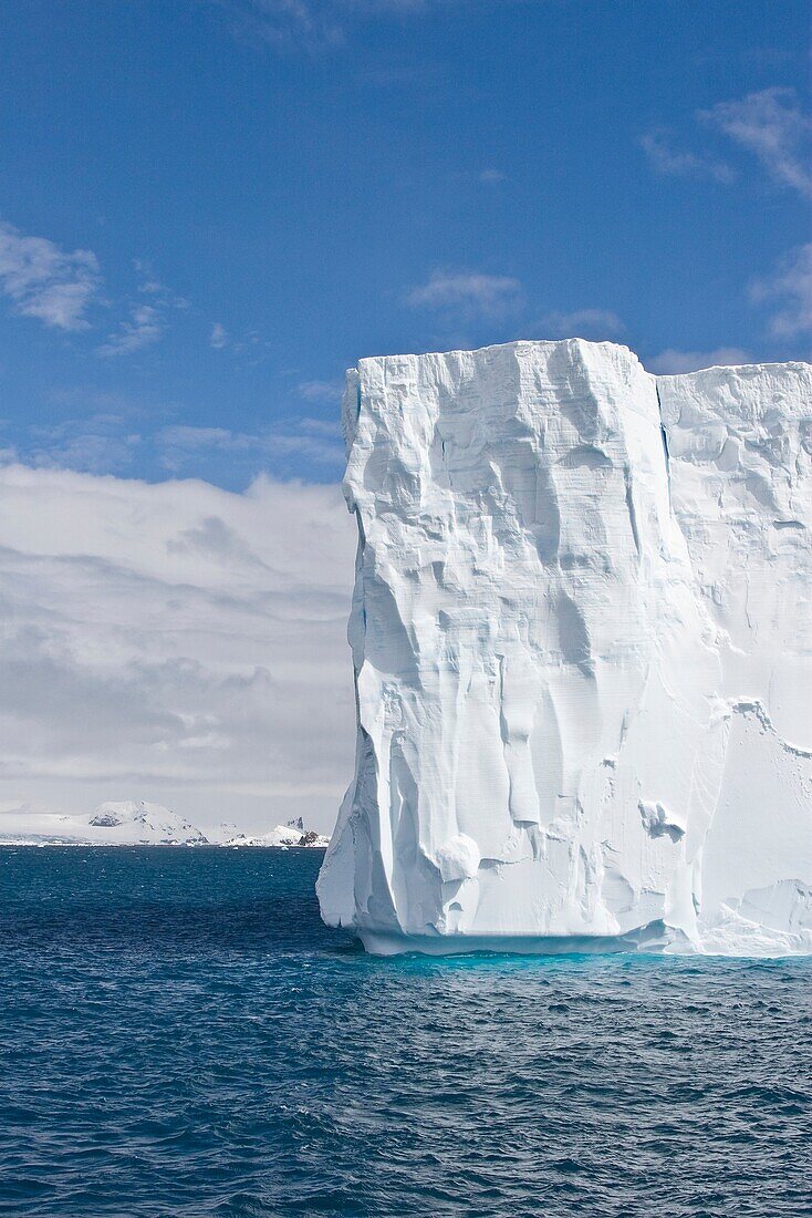 A huge tabular iceberg in the Drake Passage approaching the Antarctic Peninsula during the summer months  More icebergs are being created as global warming is causing the breakup of major ice shelves and glaciers