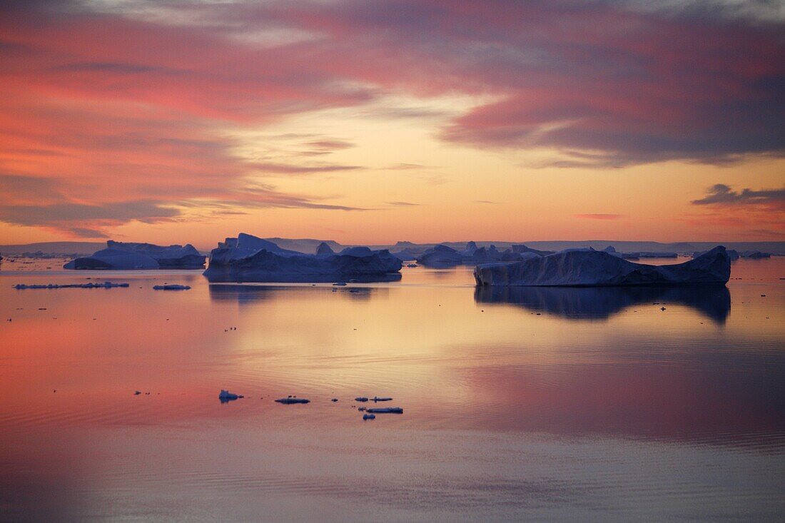 Sunset on fresh sea ice and tabular icebergs in the Weddell Sea, Antarctica