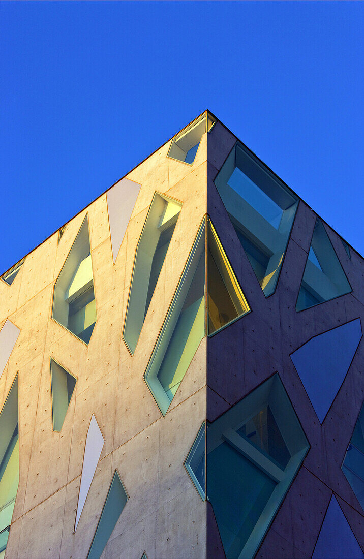 The afternoon sun illuminates the concrete and glass exterior of the Tod's Building (Italian Luxury Leather), designed by Japanese architect, Toyo Ito, on Omotesando Avenue in the trendy yet upscale Harajuku District of Tokyo, Japan.