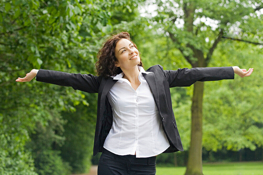 Businesswoman relaxing in a park
