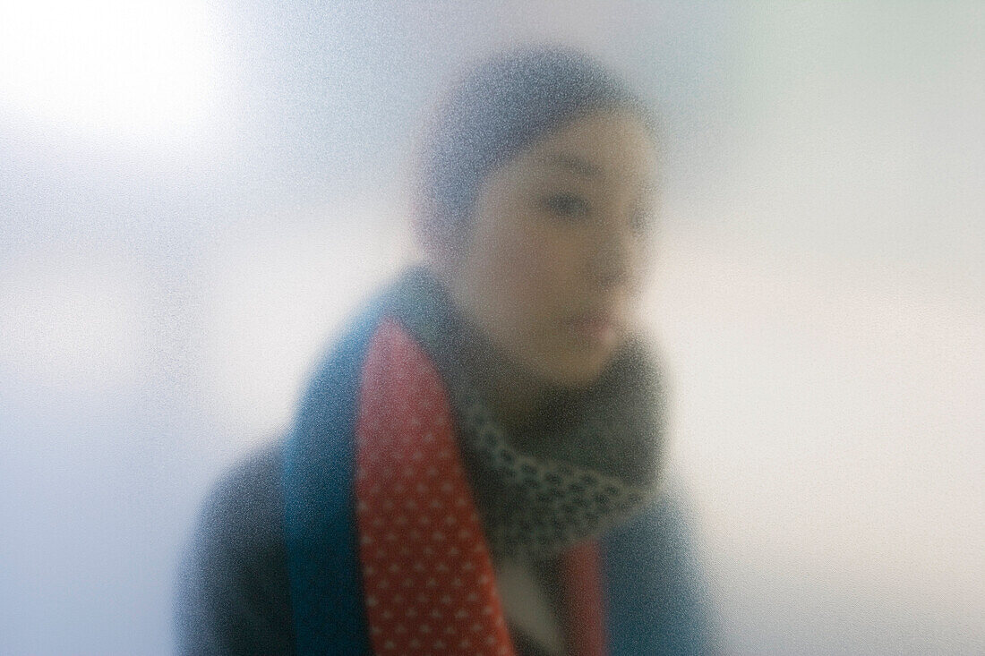 The softened figure of a Japanese woman is seen through the frosted glass at the entrance to the National Art Center Tokyo, designed by architect Kisho Kurokawa with the largest exhibition space in Japan, and located in the upscale Roppongi District of To