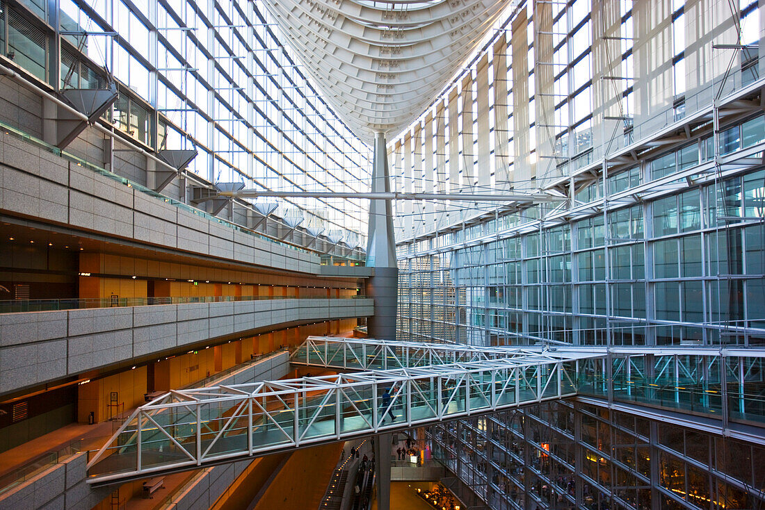 A wide-angle interior view captures the spacious 60-meter high atrium's laminated-glass and steel structure in the hull-shaped Glass Building, the main entrance hall for the Tokyo International Forum (Japan's largest conference, art, and congress ce [...]
