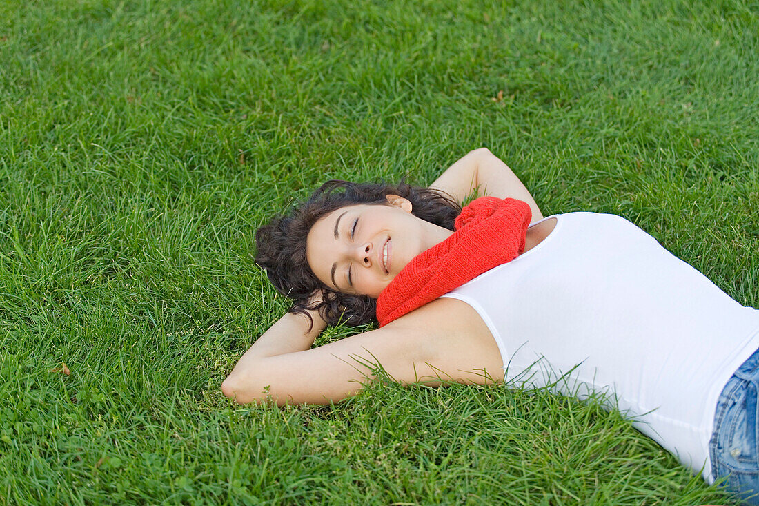 Beautiful woman lying down in park