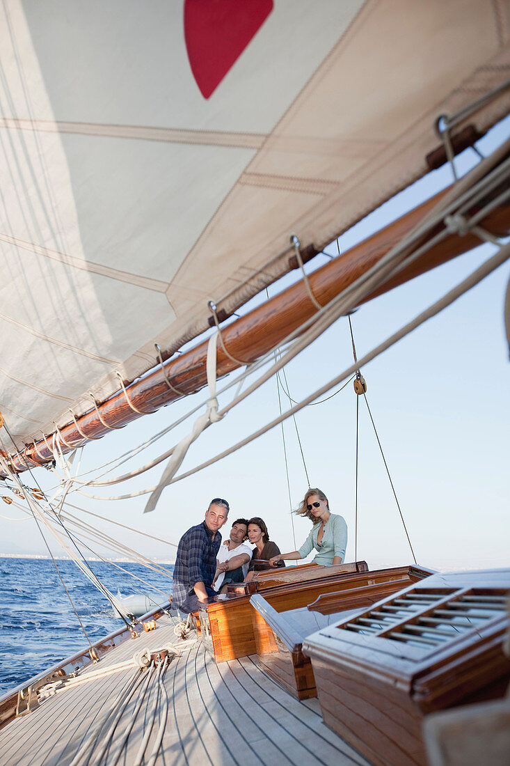 two couples sitting on deck of a boat