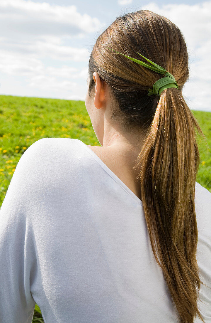 Woman with grass tied in hair