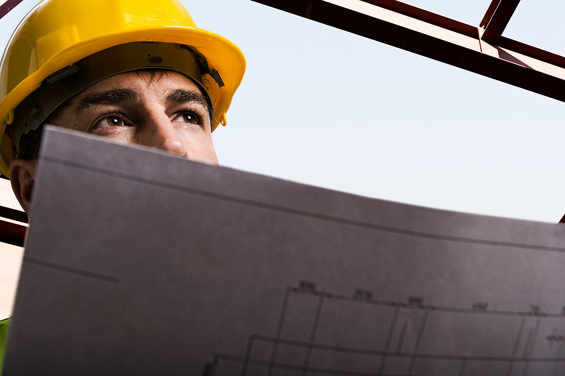 Construction worker holding drawings. Construction worker holding drawings
