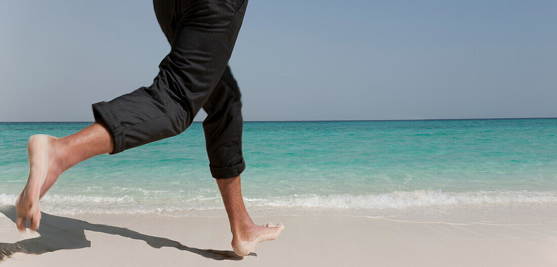 Businessman running on tropical beach. Businessman running on tropical beach