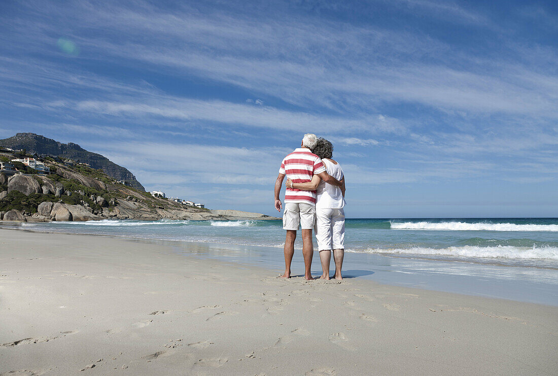 Older couple hugging on beach. Older couple hugging on beach