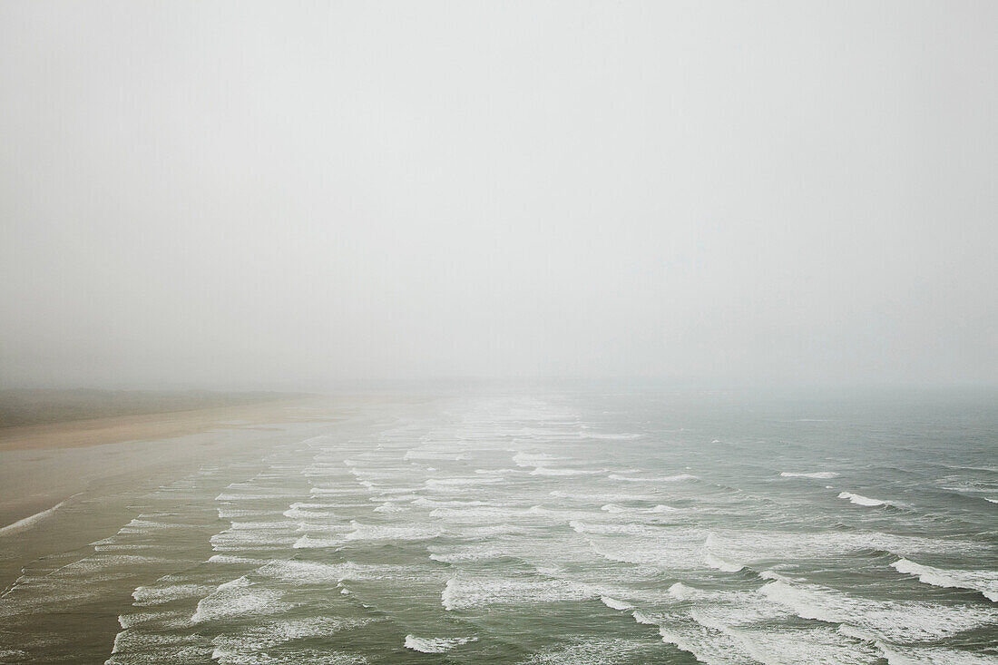 Waves crashing on foggy beach. Waves crashing on foggy beach
