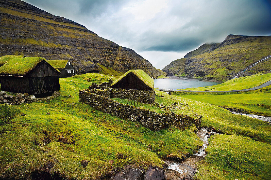 Stone houses on grassy mountainside. Stone houses on grassy mountainside