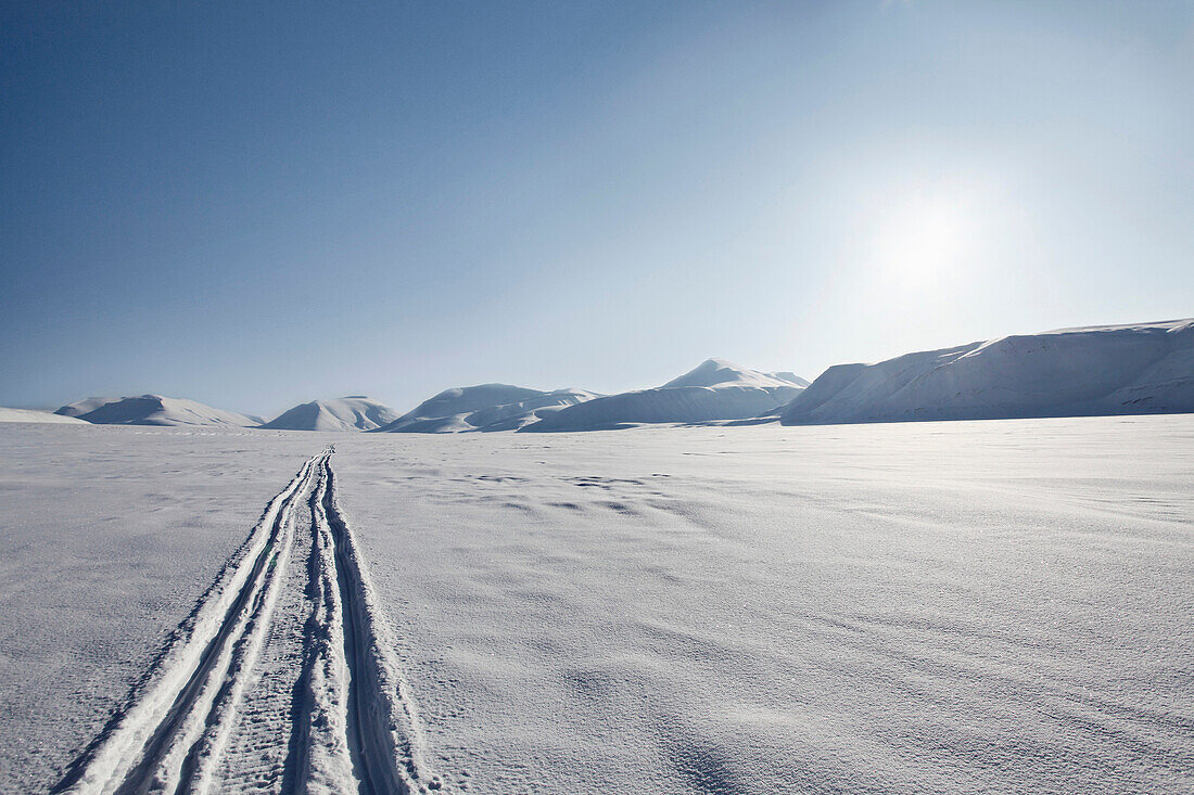 Tire tracks in snow_covered field. Tire tracks in snow_covered field