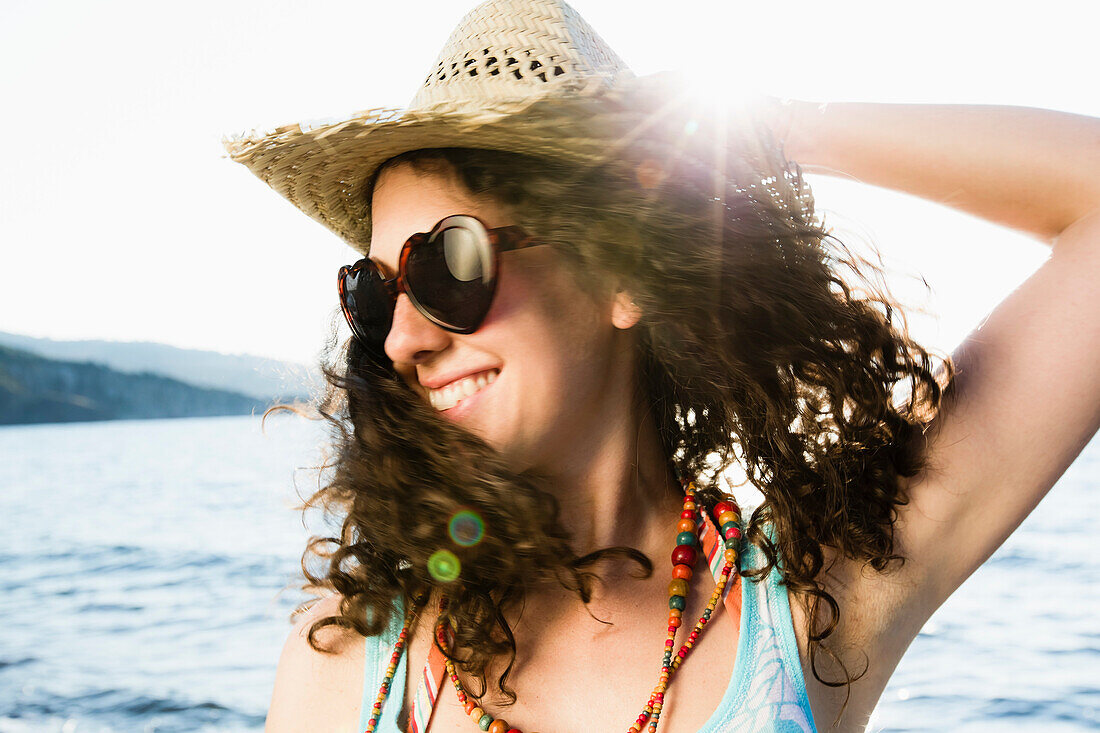Woman in straw hat smiling on beach. Woman in straw hat smiling on beach