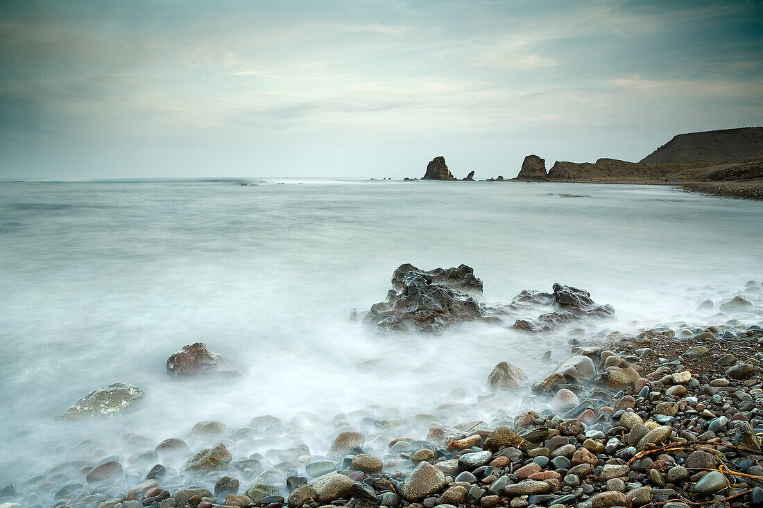 Time lapse view of waves on rocky beach. Time lapse view of waves on rocky beach