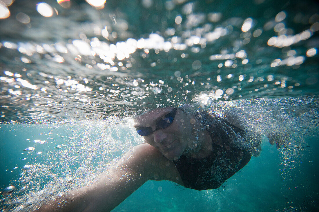 Swimmer training in ocean. Maluaka Beach Park