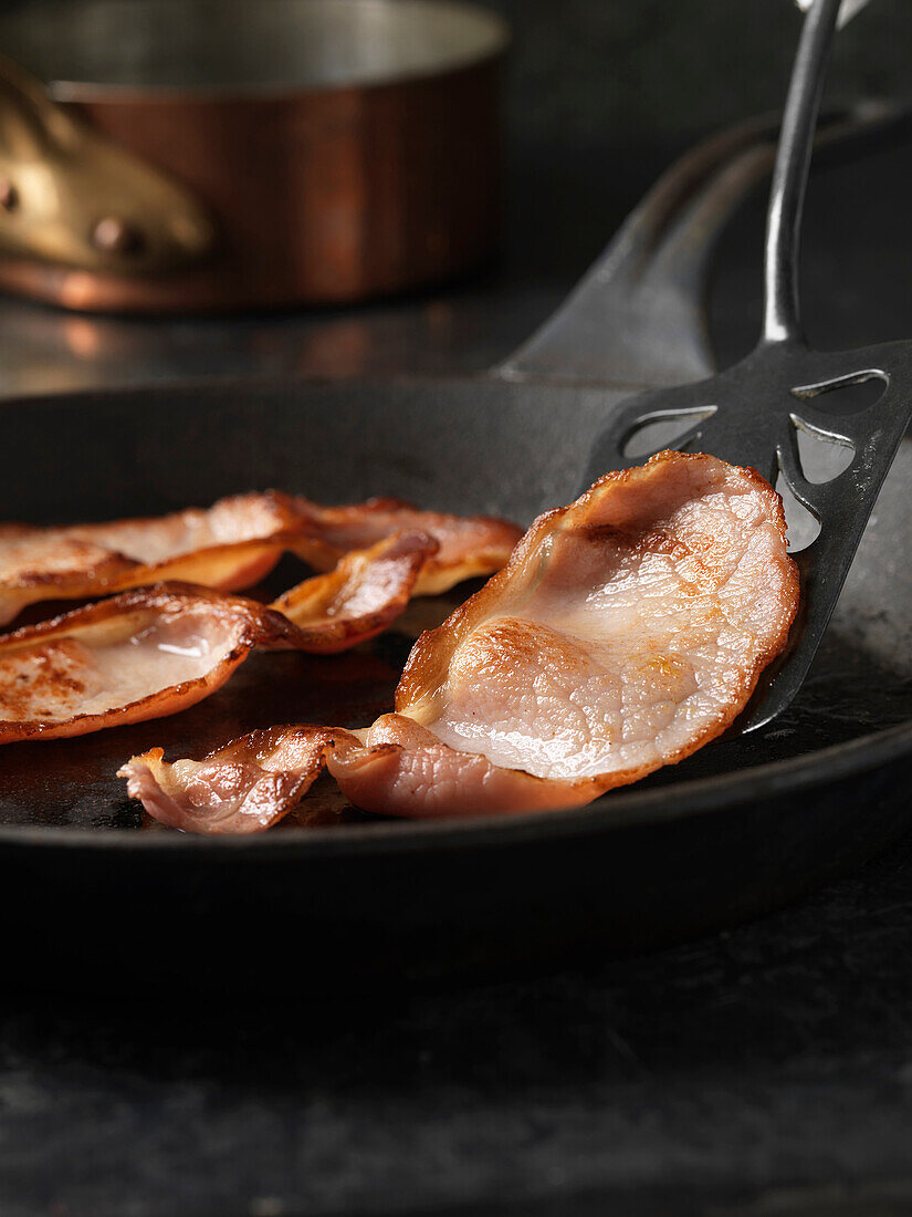 English bacon in frying pan. Back Bacon being Fried