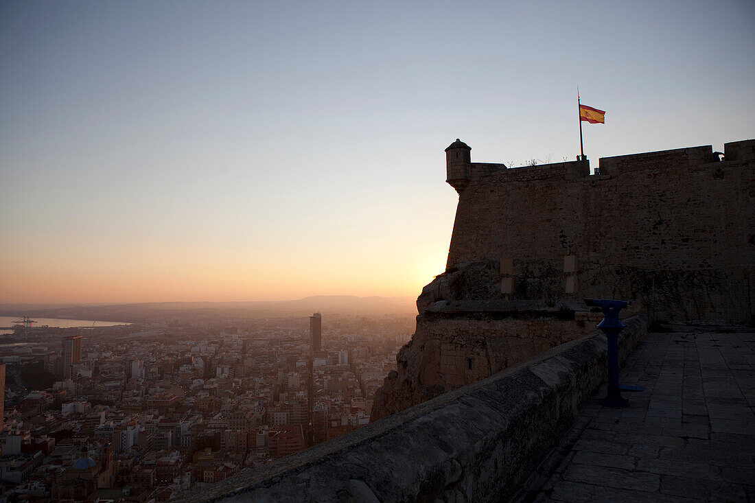 Silhouette of castle overlooking city. View from Santa Barbara Castle, Alicante, Spain