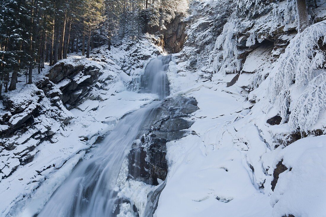 The Krimml waterfalls in the National Park Hohe Tauern during winter in ice and snow  The middle Fall  The Krimml waterfalls are one of the biggest tourist attractions in Austria and the Alps  They are visited by around 400 000 tourists every year  The wa