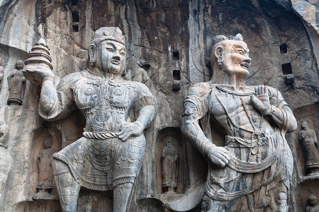 Carved statues, Fengxian Temple, Longmen Grottoes and Caves, Luoyang, Henan Province, China  Tang Dynasty