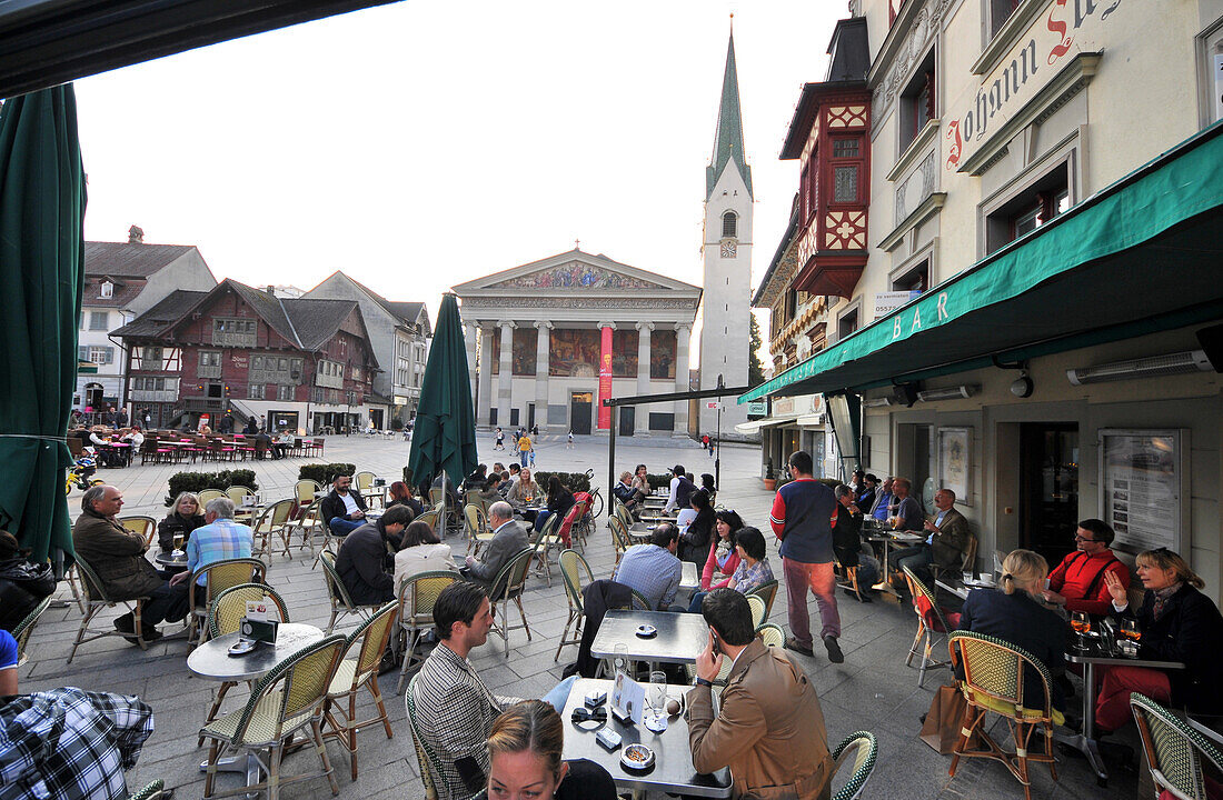 People in street cafes at the red house, Dornbirn, Vorarlberg, Austria, Europe