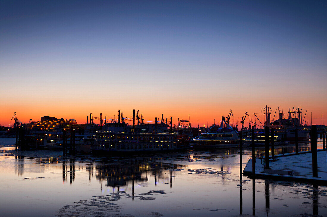 Silhouette of cranes and ships in the harbour, evening light, Hamburg, Germany