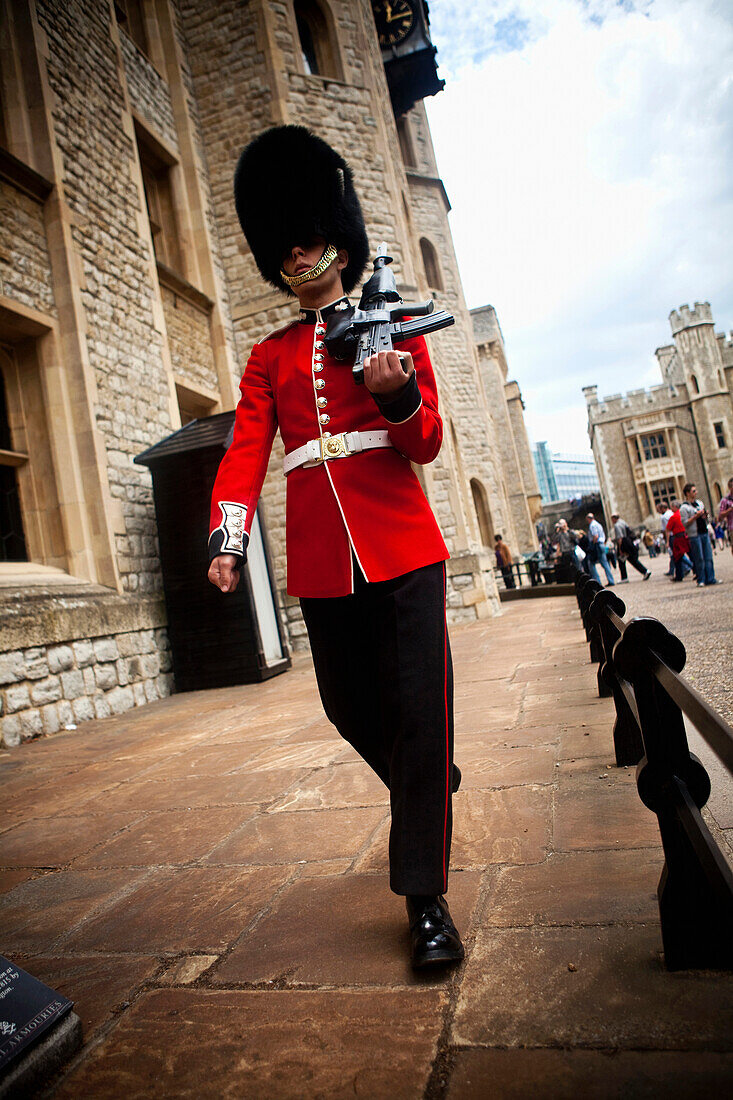 Coldstream Guard sentry patrolling the entrance to the Jewel House, Tower of London, London, England