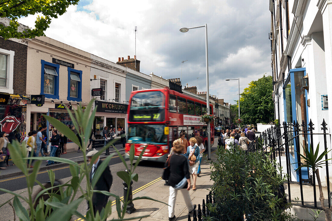 Bus and shoppers on Pembridge Road, Notting Hill, London, England