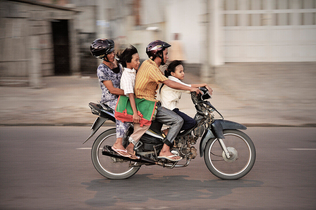 Vietnamese family riding on a motorbike, Mui Ne, Vietnam