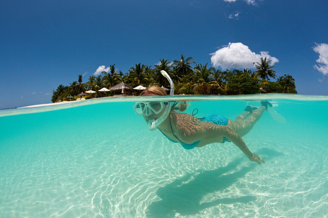 Woman snorkeling at Kurumba Island, North Male Atoll, Indian Ocean, Maldives