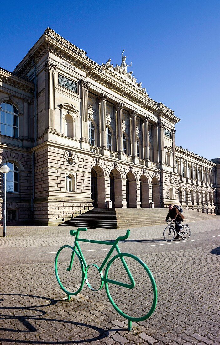 Bike park sign and cyclist in front of university building, Strasbourg, Alsace, France