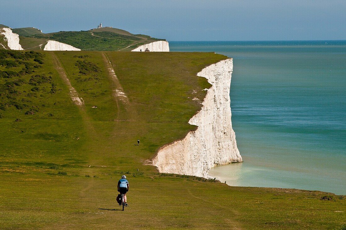 Cyclist on Chalk cliffs of the Seven Sisters, South Dawns Way, Sussex, England, UK