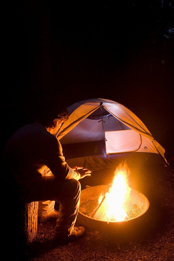 Man by campfire at South Whidbey State Park, Whidbey Island, Washington