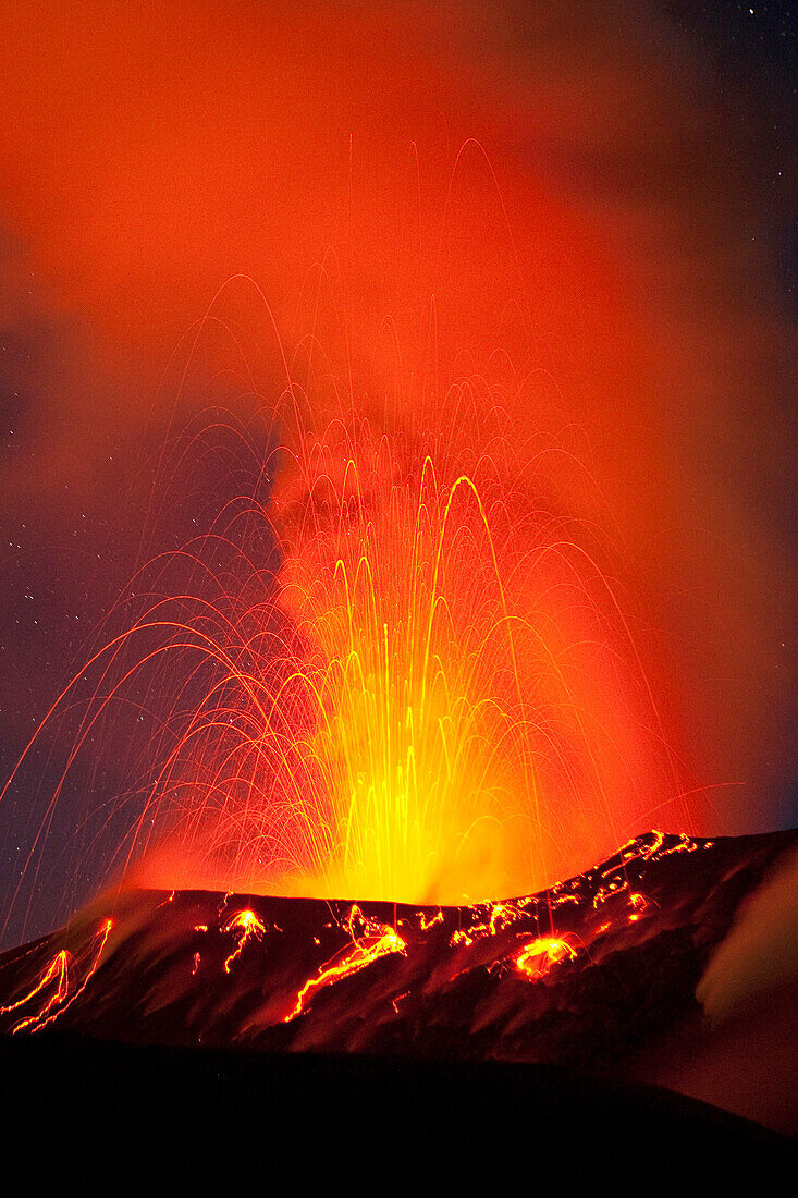 Red hot lava and sparks erupting from the Tavurvur volcano at night, Rabaul, East New Britain, Papua New Guinea, Melanesia- Pacific