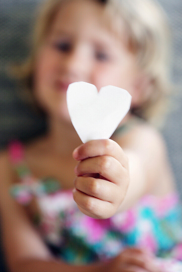 Little girl holding a paper heart, Vienna, Austria