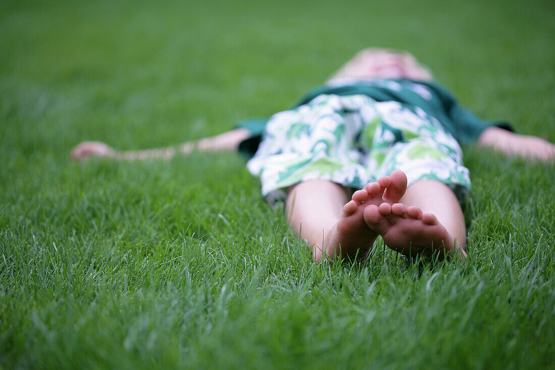 Boy lying in grass, Vienna, Austria