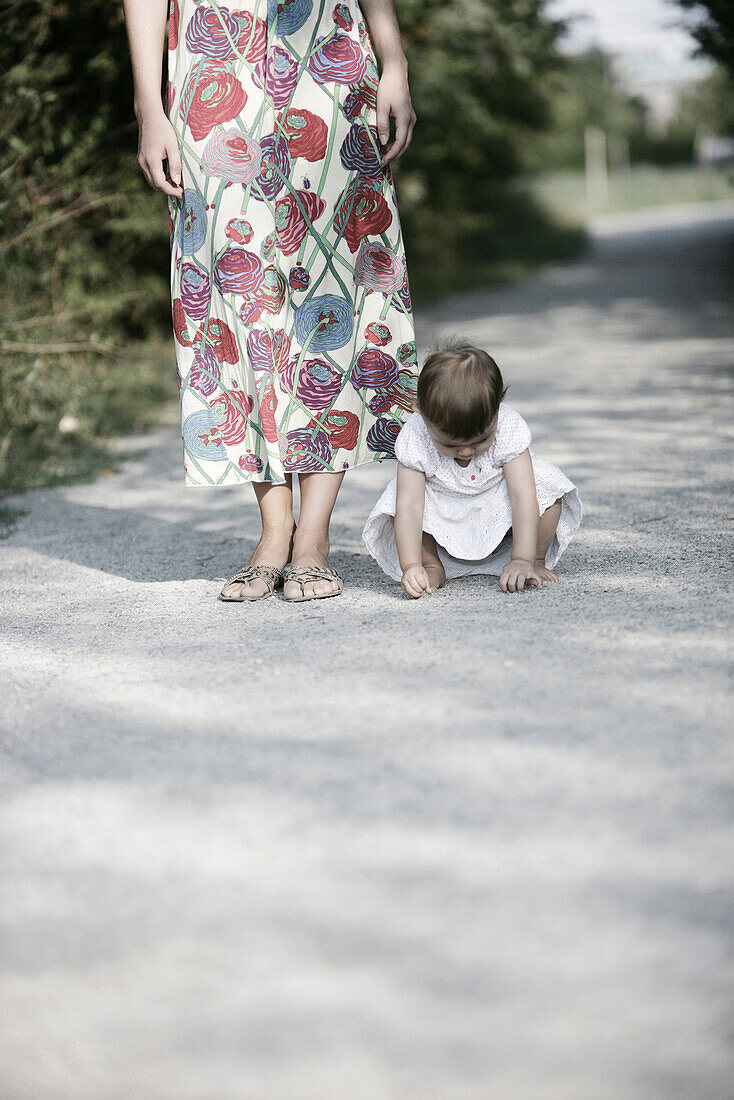 Baby girl playing on graveled path, Old Danube, Vienna, Austria