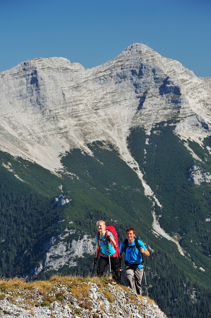 Young woman and young man hiking, Guffert in background, Unnutz, Brandenberg Alps, Tyrol, Austria